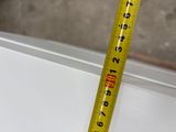 a measuring tape that is on the edge of a window sill