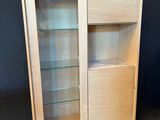 a close up of a wooden cabinet with glass shelves