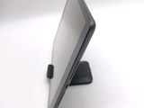 a tablet computer sitting on a stand on a white surface