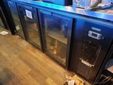 bottles of beer are sitting on top of the refrigerators in the kitchen