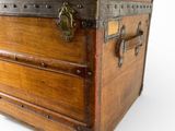 an old wooden trunk with a metal latch on it