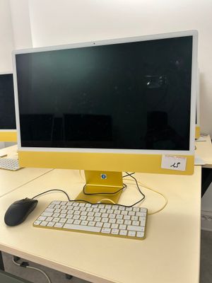 two computer monitors and a keyboard on the desk