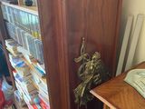 a tall wooden cabinet with a clock on top of it