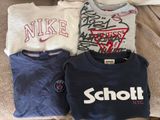 three t - shirts that are on a couch with graffiti on them
