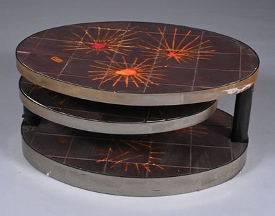 a picture of a three tiered coffee table with a design on it