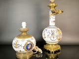 pair of antique porcelain lamps on a black table with a gray background