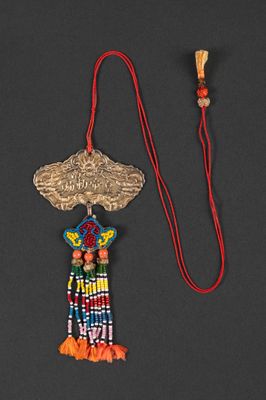 a close up of a necklace on a red string