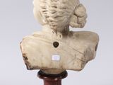 a white marble bust of a woman on a wooden base