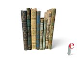 several old books are stacked on top of each other on a white surface