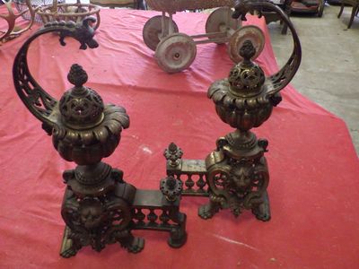 two metal objects sitting on a red table cloth