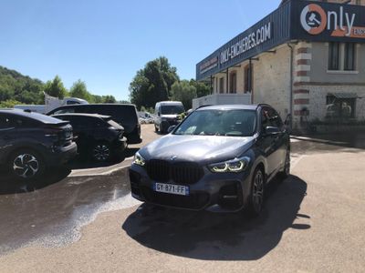 a black bmw suv parked in front of a building