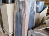 a pile of boxes and a refrigerator in a warehouse