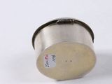 a close up of a metal object on a white surface