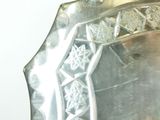 a mirror that has a silver frame with a design on it