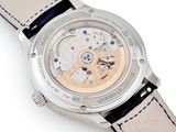 a close up of a watch on a white surface