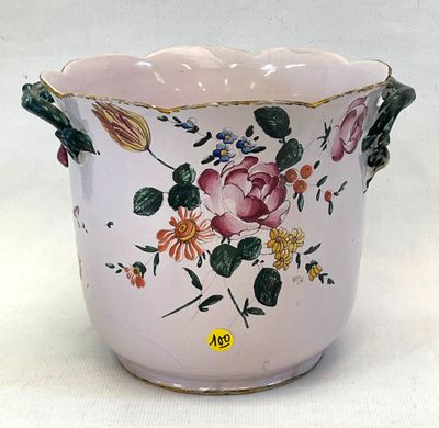a pink vase with flowers on it on a white surface