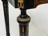 an image of a black and gold table with a clock on top of it