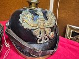 a helmet on a red cloth with a gold eagle on it