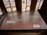 many boxes of electronic equipment sitting on a shelf
