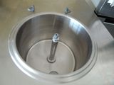 a stainless steel sink in the middle of a kitchen