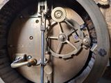 a close up of a metal clock with a clock face on it