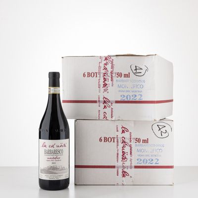 two boxes of wine and a bottle of wine sitting on a table