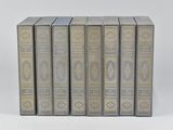 six books in a row on a white surface