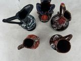 four small vases are sitting next to each other on a white surface
