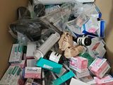 a cardboard box full of medicine and other medical supplies