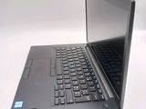 a laptop computer sitting on a table with a keyboard