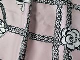 a close up of a scarf with chains and flowers on it