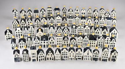 a close up of a group of small houses on a white surface