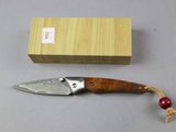 a knife that is laying on a table next to a box
