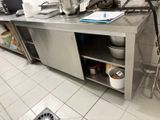 a kitchen counter with a bunch of pots and pans on it