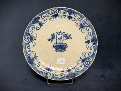 an old blue and white plate with a bird on it