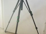 a tripod with a camera on it in the corner of a room
