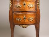 an antique chest of drawers with a marble top on a stand