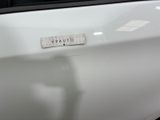 a close up of a white car with a sticker on it