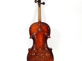 an old violin is sitting on a white surface with a white background