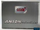 a box of asson collectibles sitting on a table