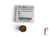 a close up of a coin and a barcode on a white surface