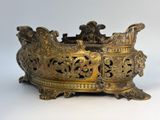 an antique brass bowl with ornate designs on a white background