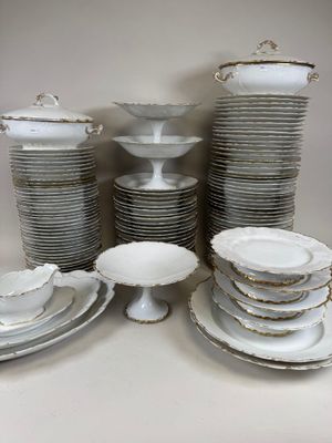 a lot of plates and bowls on the table