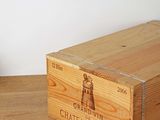 a wooden crate sitting on a wooden floor next to a wall