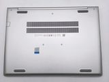 a close up of a silver laptop on a white surface