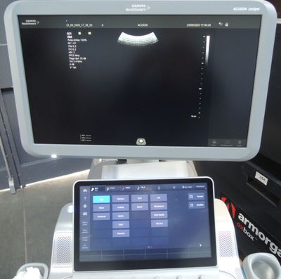 a laptop computer sitting on top of a table next to a monitor