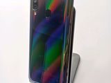 the back view of a phone with a rainbow - colored back