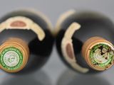 two bottles of wine sitting next to each other on top of a table