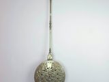 une cuillère en argent suspendue à un crochet fixé au mur