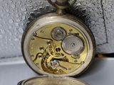 a pocket watch that is sitting on a table